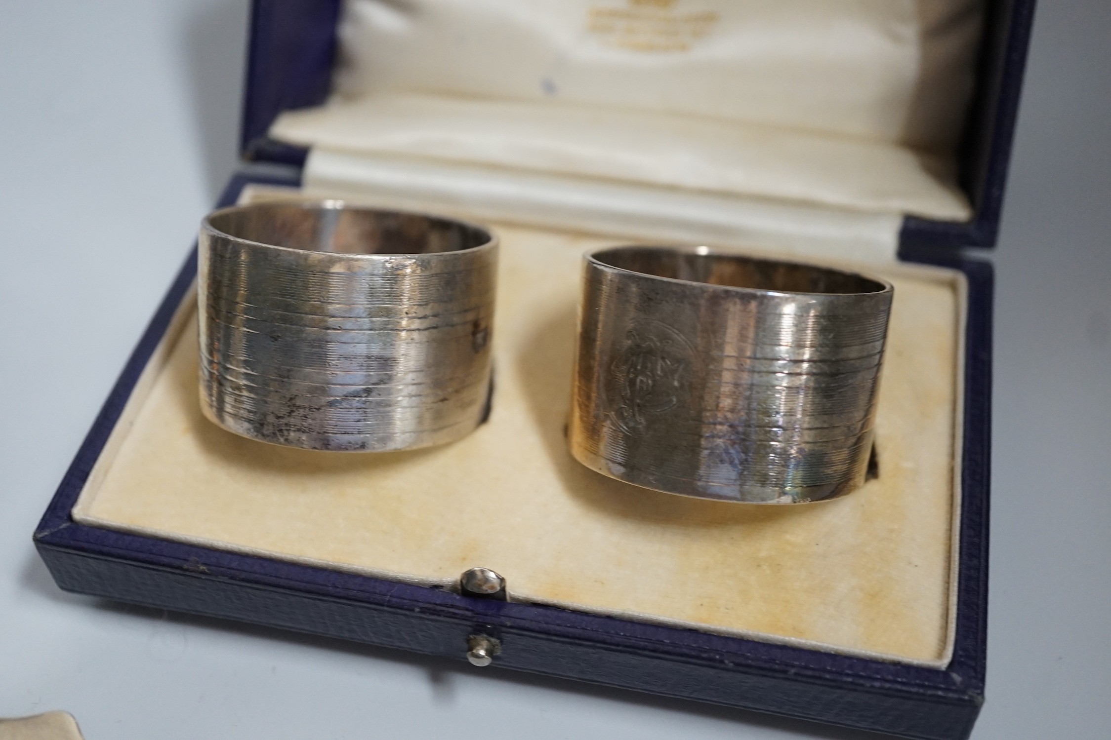 A group of silver including a George V silver inkstand, 17.7cm, a cased pair of napkin rings and two silver christening mugs, one Victorian.